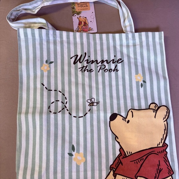 Disney Handbags - Disney Winnie the Pooh Tag with Red and Green Highlights